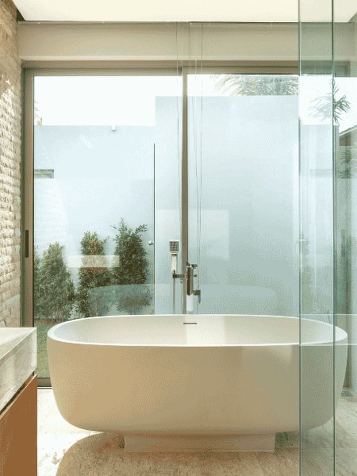 Contemporary bathroom with freestanding bathtub and natural light